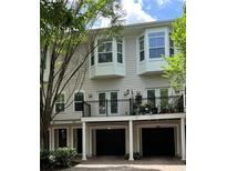 Inviting townhome featuring bay windows, a balcony, and attached garages, perfect for comfortable living at 793 Inman Mews Ne Dr, Atlanta, GA 30307