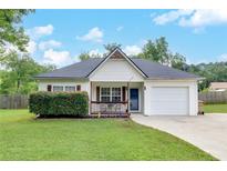 Charming single-story home featuring a well-manicured lawn and an attached one car garage at 15 Echota Ne Rd, Cartersville, GA 30121
