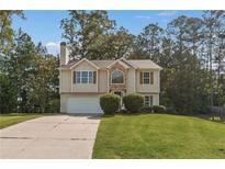 Charming two-story home features a stone accent wall and attached two-car garage at 5960 Castlegate Dr, Douglasville, GA 30135