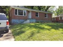 Charming single-story brick home with a well-maintained front yard, offering classic curb appeal at 2545 Saint Patrick Se St, Atlanta, GA 30317