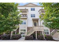 Charming three-story townhome with stone accents, inviting staircase, and lush green landscaping at 3116 Quantum Ln, Atlanta, GA 30341