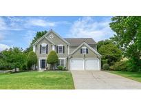 Charming two-story home with a well-manicured lawn and a two-car garage at 3635 Bardfield Ct, Cumming, GA 30041