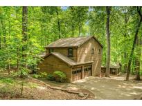 Charming cabin-style home with a two-car garage nestled amongst mature trees at 2269 Sparrow Ridge Ne Dr, Marietta, GA 30066