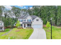 Charming two-story home with a well-manicured lawn and a welcoming front porch perfect for relaxing at 4056 Friendship Creek Dr, Buford, GA 30519