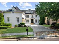 Beautiful white brick home featuring a well-manicured lawn and a long driveway at 745 Glengate Pl, Atlanta, GA 30328