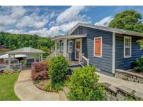 Charming blue home with a landscaped yard, covered dock, and tranquil lake views at 22 Waters Bridge Cir, Covington, GA 30014