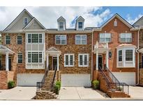 Charming brick townhomes featuring well-manicured landscaping and attached garages at 3895 Old Atlanta Station Se Dr # 1, Atlanta, GA 30339