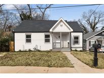 Charming white brick home with a gabled porch and well-maintained lawn at 1104 Oak Knoll Se Ter, Atlanta, GA 30315