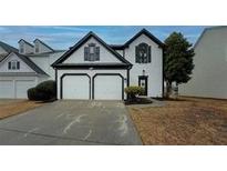 Charming two-story home featuring an attached two-car garage, neutral siding, and well-maintained landscaping at 2587 Alvecot Se Cir, Atlanta, GA 30339