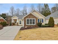 Charming one-story home with stone accents, manicured landscaping, and a welcoming front porch at 6775 Marlow Dr, Cumming, GA 30041