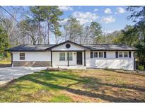 Charming single-story home featuring a freshly painted exterior and a neatly maintained front yard at 3698 Sharon Dr, Powder Springs, GA 30127