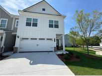 Charming two-story home featuring a two-car garage and beautifully landscaped front yard at 1177 Chastain Dr, Sugar Hill, GA 30518