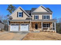 Charming two-story home with stone accents, a two-car garage, and a welcoming front porch at 30 Grand Georgian Ne Ct, Cartersville, GA 30121