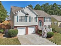 Inviting two-story home with a brick-accented facade, two-car garage, and well-manicured lawn at 3709 Mcguire Nw St, Kennesaw, GA 30144