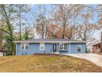 Charming blue ranch-style home featuring a well-maintained yard and a freshly paved driveway at 2899 Gresham Se Rd, Atlanta, GA 30316