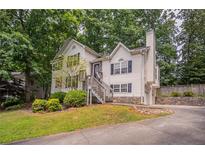 Charming two-story home with front yard landscaping, stone accents and driveway at 962 Taylors Farm Ct, Canton, GA 30115