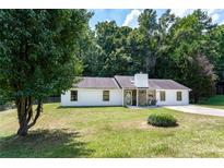 Charming single-story home featuring a manicured lawn and inviting front entrance at 3385 Huntington Ct, Douglasville, GA 30134
