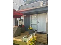 Cozy back porch with flowers and outdoor seating leading to the front door at 1044 Mariners Ct, Stone Mountain, GA 30083