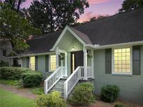 Charming home with a covered porch, painted brick, and landscaped front yard at 2259 Eastway Rd, Decatur, GA 30033