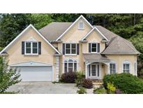 Charming two-story home with a manicured front yard and attached two-car garage at 3450 Merganser Ln, Alpharetta, GA 30022