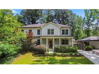 Charming two-story home featuring a covered front porch and beautifully landscaped front yard at 2505 Midway Rd, Decatur, GA 30030