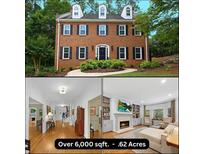 Two-story brick home with black shutters, dormer windows, and a curved walkway surrounded by mature trees at 4250 Green Ridge Dr, Marietta, GA 30062