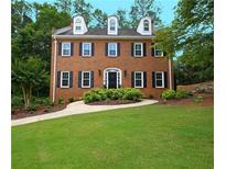 Charming brick two-story home featuring a well-manicured lawn and inviting walkway at 4250 Green Ridge Dr, Marietta, GA 30062