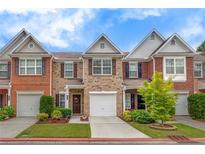 Charming brick townhome with a one-car garage and well-manicured front yard at 2336 Heritage Park Nw Cir # 11, Kennesaw, GA 30144