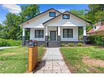 Charming home featuring a welcoming walkway, beautiful lawn, and classic black and white accents at 1363 Jonesboro Se Rd, Atlanta, GA 30315