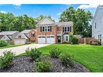 Charming brick two-story home with a well-manicured lawn and a two-car garage at 615 Rosedown Way, Alpharetta, GA 30022