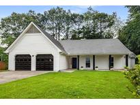Charming one-story home featuring a two-car garage and a well-manicured lawn at 5315 Bentley Hall Dr, Alpharetta, GA 30005