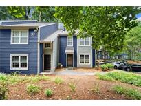 Inviting townhouse with blue siding and manicured landscaping, perfect for a comfortable and stylish living at 1384 N Crossing Ne Dr, Atlanta, GA 30329