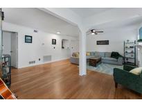 Bright living room featuring hardwood floors, white walls, and a comfortable gray sectional sofa at 1274 Branch Dr, Tucker, GA 30084