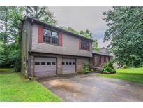 Charming two-story home featuring a two-car garage and nicely landscaped surroundings at 1744 Cum Laude Way, Lawrenceville, GA 30044
