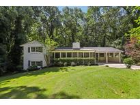 Charming exterior view of home with lush landscaping and mature trees, offering privacy and curb appeal at 2436 Ovidia Sw Cir, Atlanta, GA 30311
