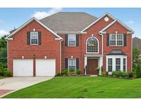 Beautiful two-story red brick home with a well-manicured lawn and a two car garage at 4203 Norbury Ct, Smyrna, GA 30080