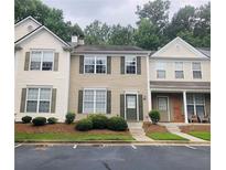 Traditional townhouse with neutral siding, green shutters, tidy lawn, and parking area at 4645 Valais Ct # 10, Johns Creek, GA 30022