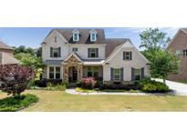 Beautiful two-story home with manicured lawn, stone accents, and charming curb appeal at 5915 Read Rd, Suwanee, GA 30024
