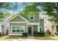 Charming two-story home with shaker siding, tidy landscaping, and sidewalk leading to the front door at 126 Wellbrook Ne Ct, Conyers, GA 30012