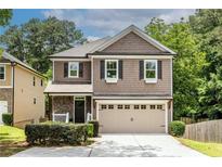 Charming two-story home with a welcoming front porch and attached two-car garage at 1542 Idlewood Rd, Tucker, GA 30084