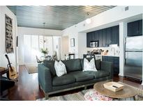 Open-concept living room featuring a modern kitchen, dining area, and comfortable seating at 620 Glen Iris Dr # 223, Atlanta, GA 30308