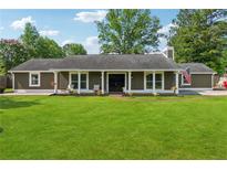 Charming single-story home with a well-manicured lawn and welcoming front porch at 3280 Pebble Hill Dr, Marietta, GA 30062