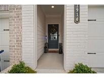 Inviting front entrance with decorative wreath and stylish black door at 1914 Carovel Way, Kennesaw, GA 30144