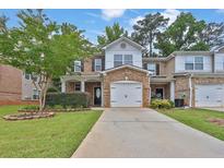 Charming townhome with brick accents, landscaping, and a well-maintained lawn at 3461 Dianthus Ln, Lawrenceville, GA 30044