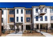 New townhouse showcasing modern design, brick accents, and wrought iron fencing at 354 Olmstead Way # 27, Alpharetta, GA 30022