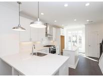 Modern kitchen featuring stainless steel appliances, white cabinets, quartz counters, and an island at 354 Olmstead Way # 27, Alpharetta, GA 30022
