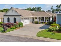 Charming single-story home with a well-manicured lawn, mature landscaping, and a two-car garage at 406 Genevieve Dr, Canton, GA 30114