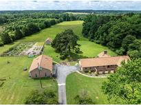 Sprawling estate featuring multiple buildings, lush greenery, and a well-maintained landscape with garden at 1502 Campground Rd, Mcdonough, GA 30252