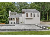 Stunning home featuring modern architecture, a landscaped yard, and a unique decorative rock border at 2683 Tritt Springs Ne Trce, Marietta, GA 30062