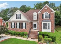 Charming two-story brick home with manicured lawn and mature trees offering great curb appeal at 3223 Thornecreek Dr, Douglasville, GA 30135